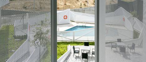 An outdoor pool area with a lifebuoy, surrounded by outdoor seating.