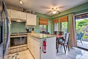 Enjoy meal preparation and dining in this well-equipped kitchen with a central island, stainless steel oven, and microwave.