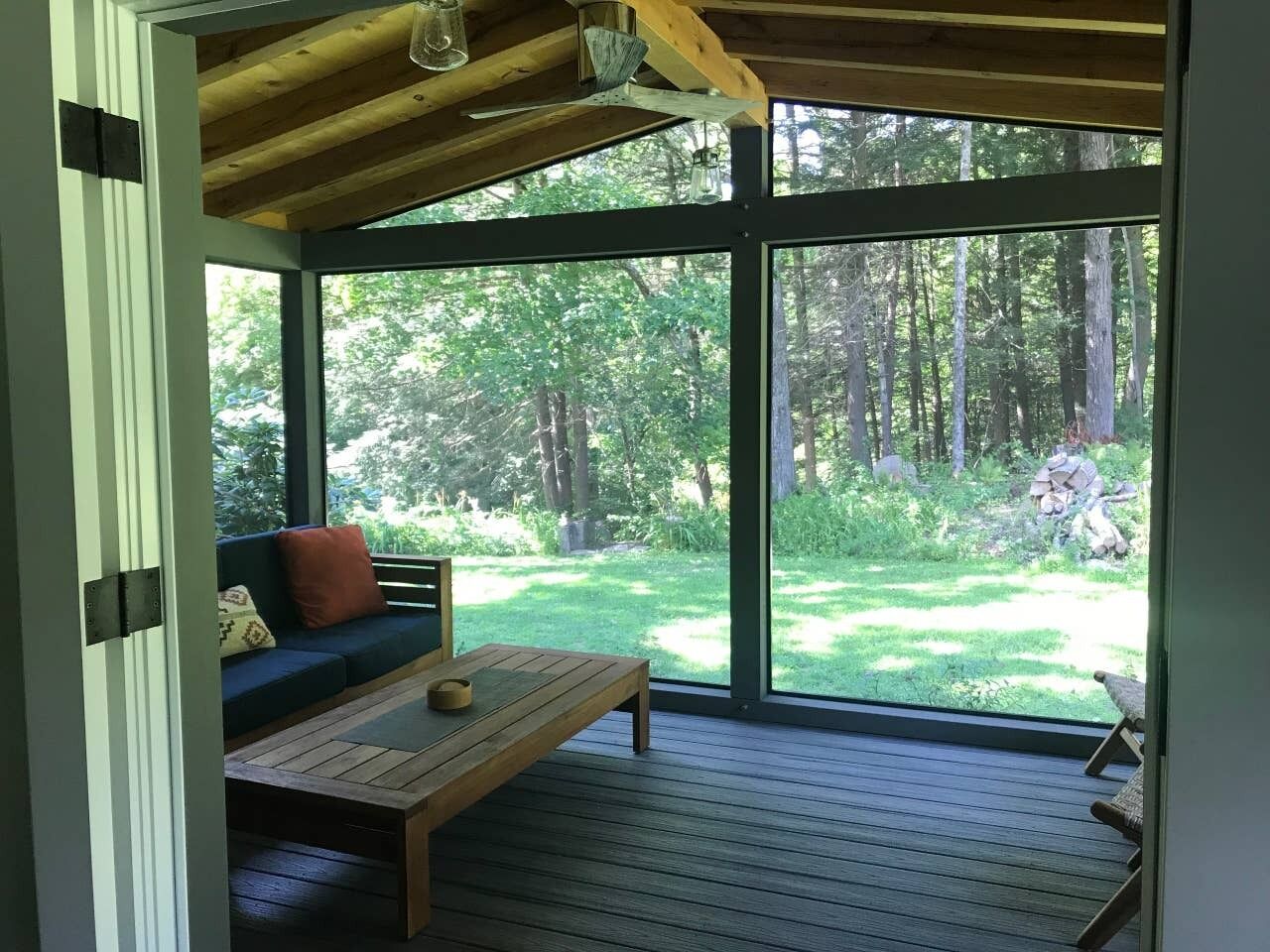 Porch opens up from dining room. Ceiling fan and lights above.  