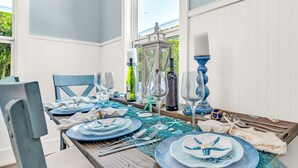 A dining table set with blue and white plates, glasses, and cutlery. - TikiBar with TV &Stereo, PrivateSpa, Heated Pool, Hammock,SUP’s, Kayaks,Bikes,FP (Islamorada)