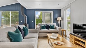 A modern living room with a sofa, coffee table, and television. - The Retreat, Strawberryfield Park -  a lodge that sleeps 4 guests  in 2 bedrooms (Cheddar)