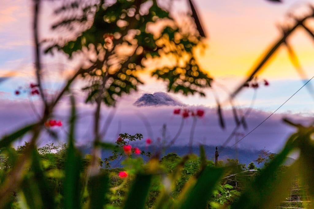 A mountain landscape with a sunset in the background.