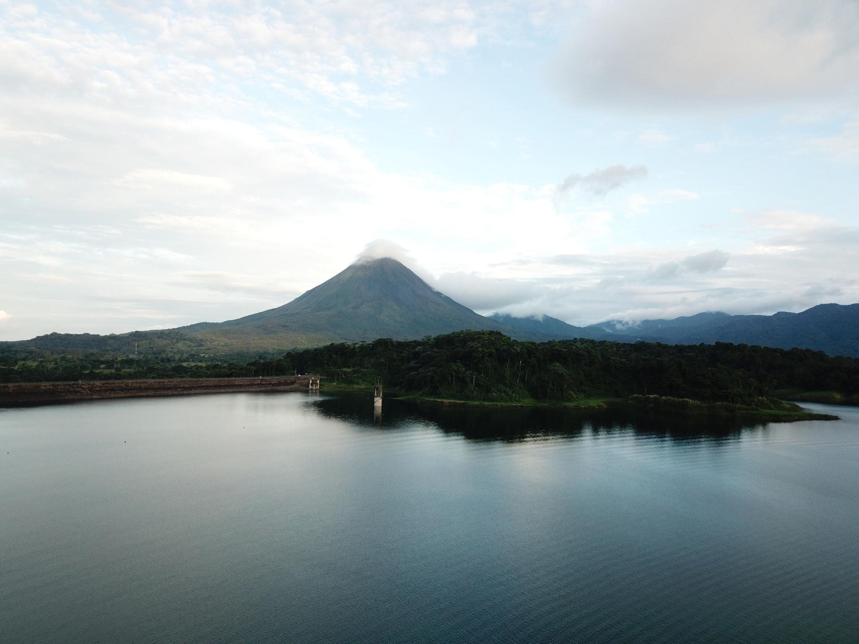 A calm lake with a mountain in the background.