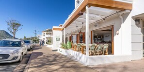 Stroll to the ground-floor cafe with outdoor seating and enjoy a meal amidst the bustling street scene.