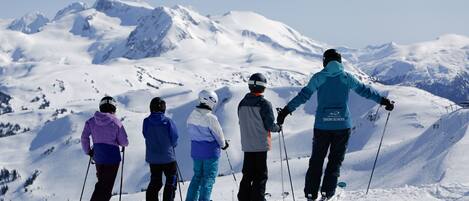 A group of skiers on a snowy mountain slope.