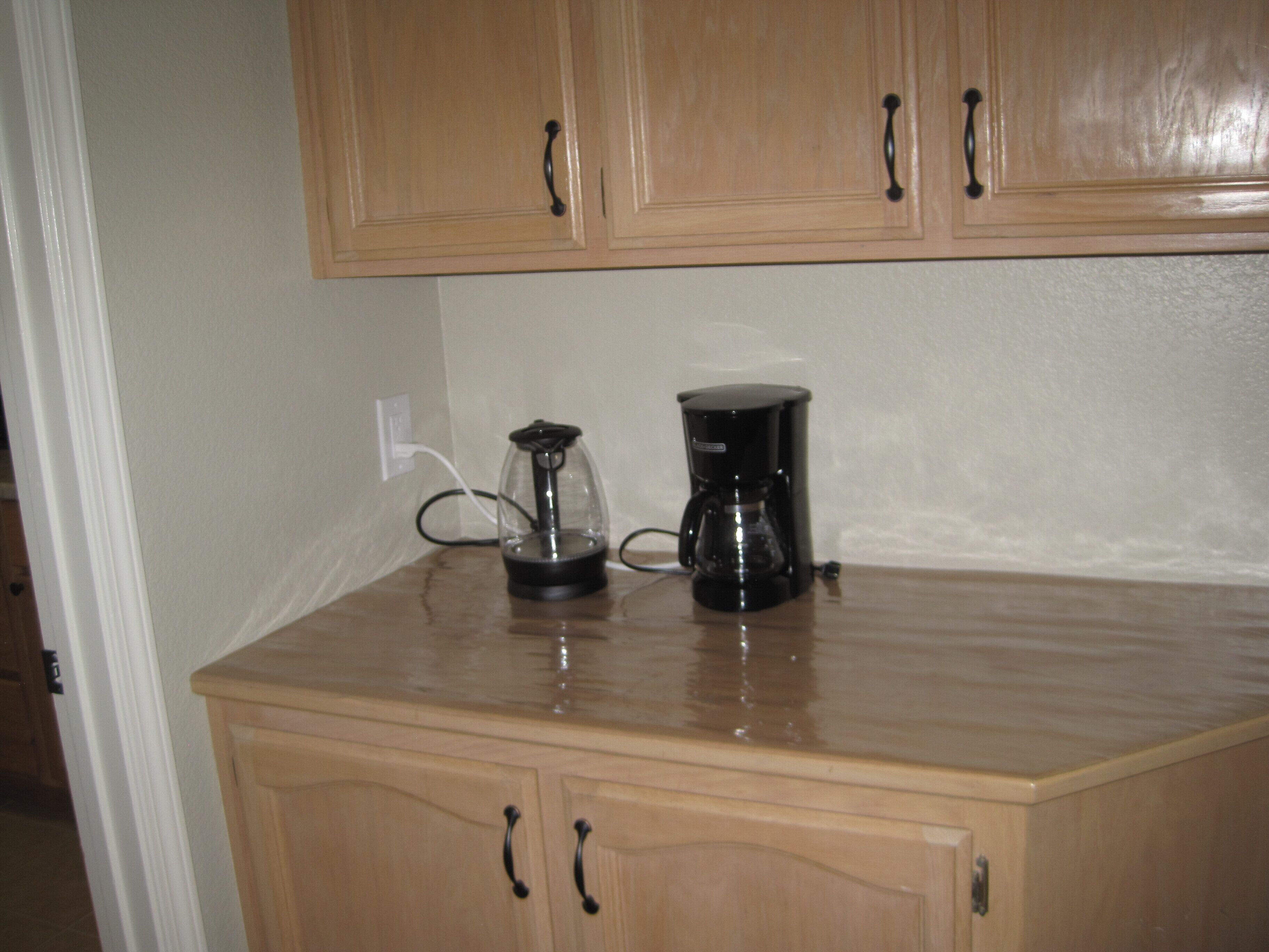 A kitchen with wooden cabinets and a countertop.
