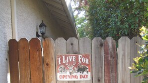 A wooden fence with a sign that reads "I LIVE FOR OPENING DAY."