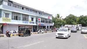 A multi-story building with various commercial establishments including a Chinese restaurant, a clinic, and a pharmacy. - Ratnoop Inn-enjoy the classic stay (Port Blair)
