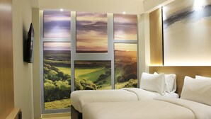 A hotel room with a large window, a bed, a TV, and a wooden headboard. - Best Western Setiabudhi Bandung (Bandung)