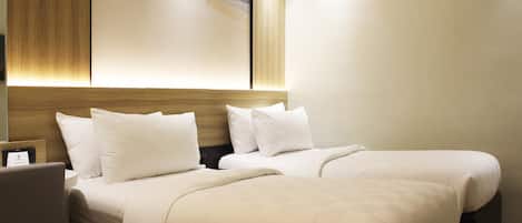 A hotel room with two beds, a wooden headboard, and a large abstract painting on the wall.