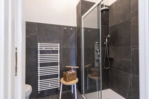 Shower, hair dryer, towels, toilet paper