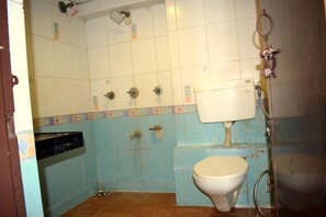 A bathroom with a toilet, a shower, and a sink. - Hotel Royal Stay (Ahmedabad)