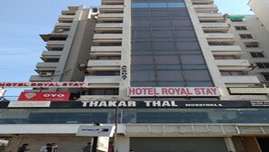 A multi-story building with signs for 'Hotel Royal Stay' and 'Thakar Thal'. - Hotel Royal Stay (Ahmedabad)