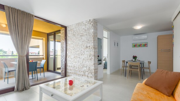 A modern living room with a glass coffee table, a sofa, and a dining area with a table and chairs. - Right in the Porec center, near the beach,WiFi,air conditioning,garage, elevator (Porec)