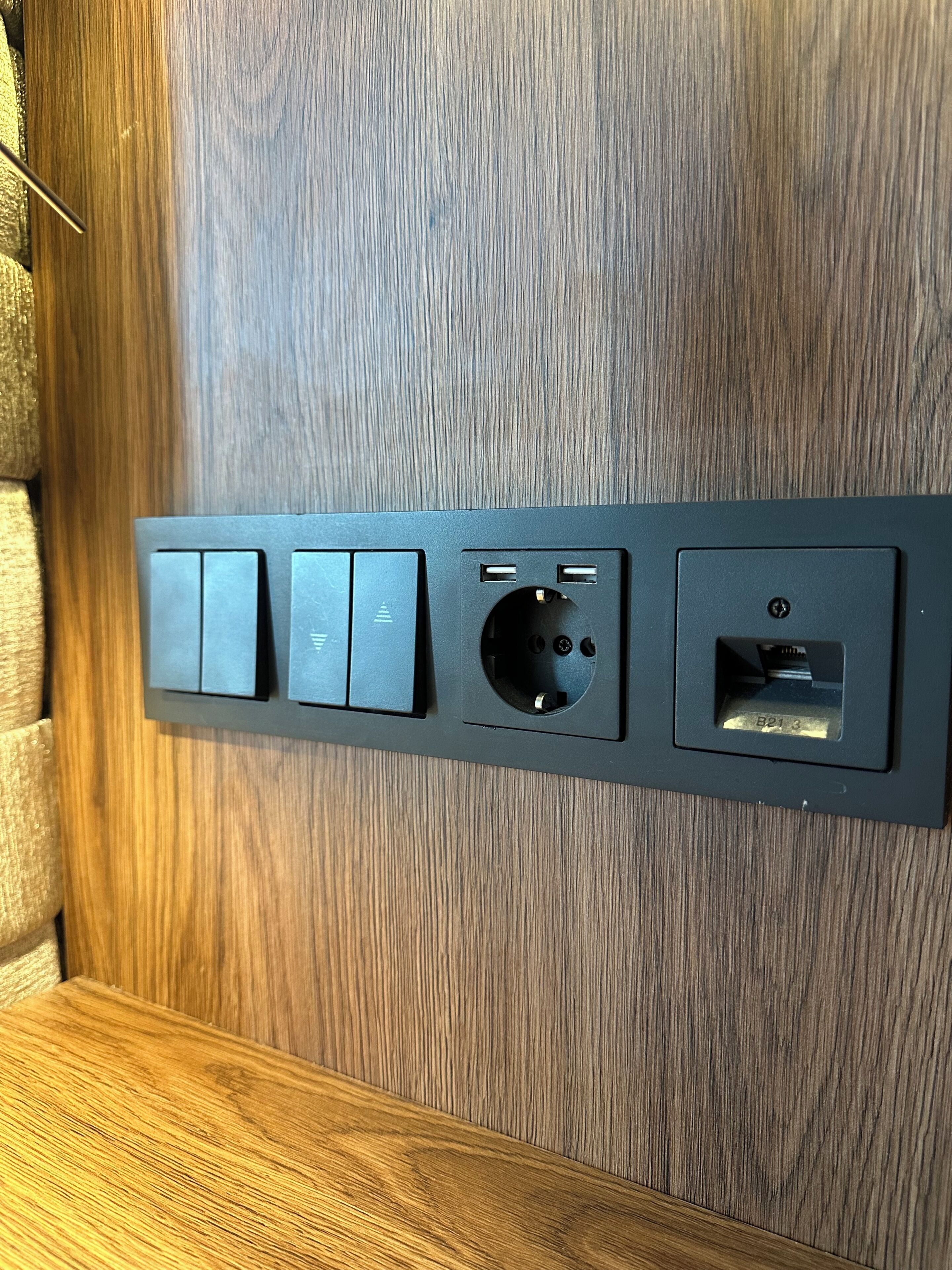 A wall-mounted electrical panel with multiple switches and sockets.