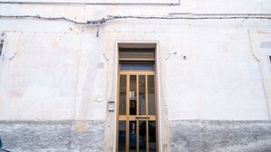 A building facade with a central window, a small ledge below the window, and a visible utility box to the left. - CasaBattista10 Comfort and Relax (Matera)