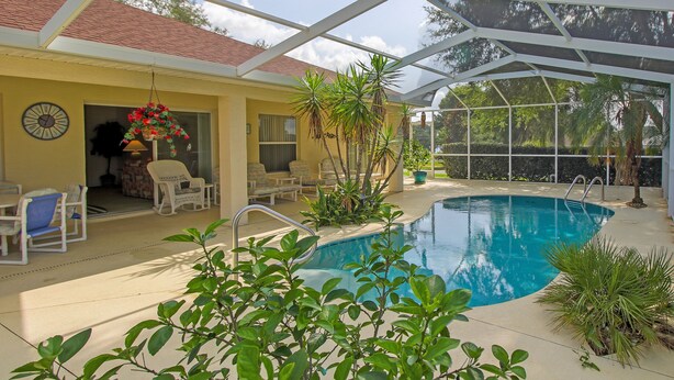 A covered outdoor pool area with lounge chairs, a clock, and potted plants. - Perfect Family Gateway At Silverthorne 3 Bedroom Home by RedAwning (Hernando)