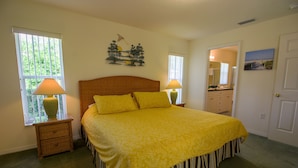 A bedroom with a bed, two bedside tables, a window, a door, and a wall-mounted artwork. - Perfect Family Gateway At Silverthorne 3 Bedroom Home by RedAwning (Hernando)