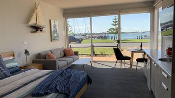 Studio 1 Waterfront | Living area | 58-inch Smart TV with digital channels, TV, streaming services