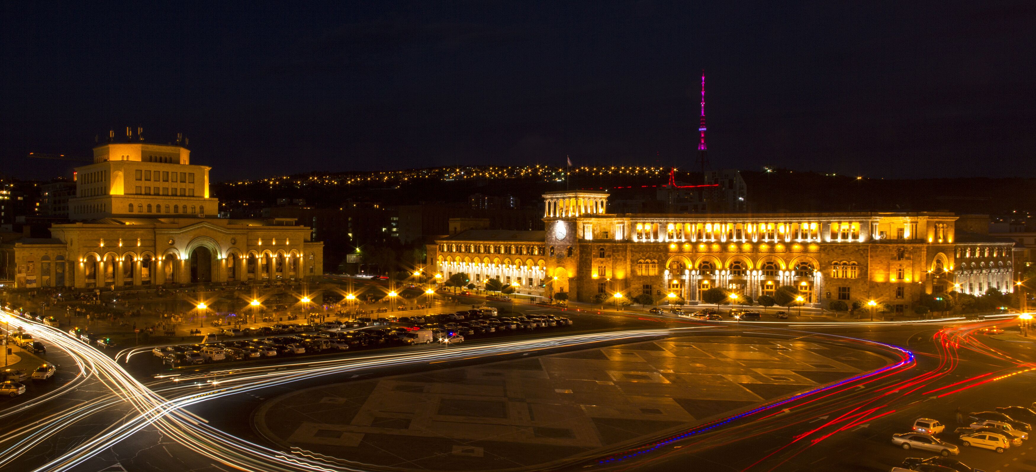 A large, illuminated building with a grand facade and a prominent tower.