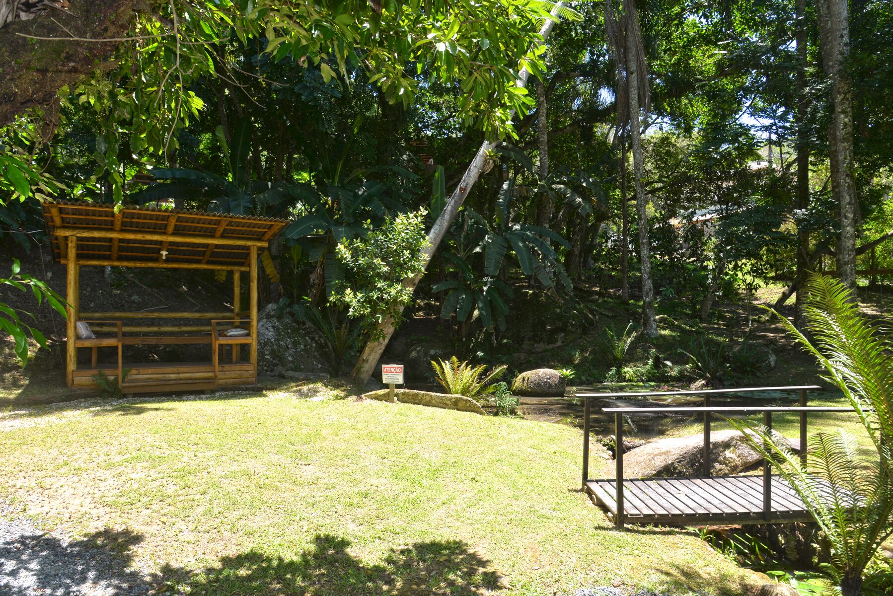 Una pérgola de madera en un exuberante jardín.