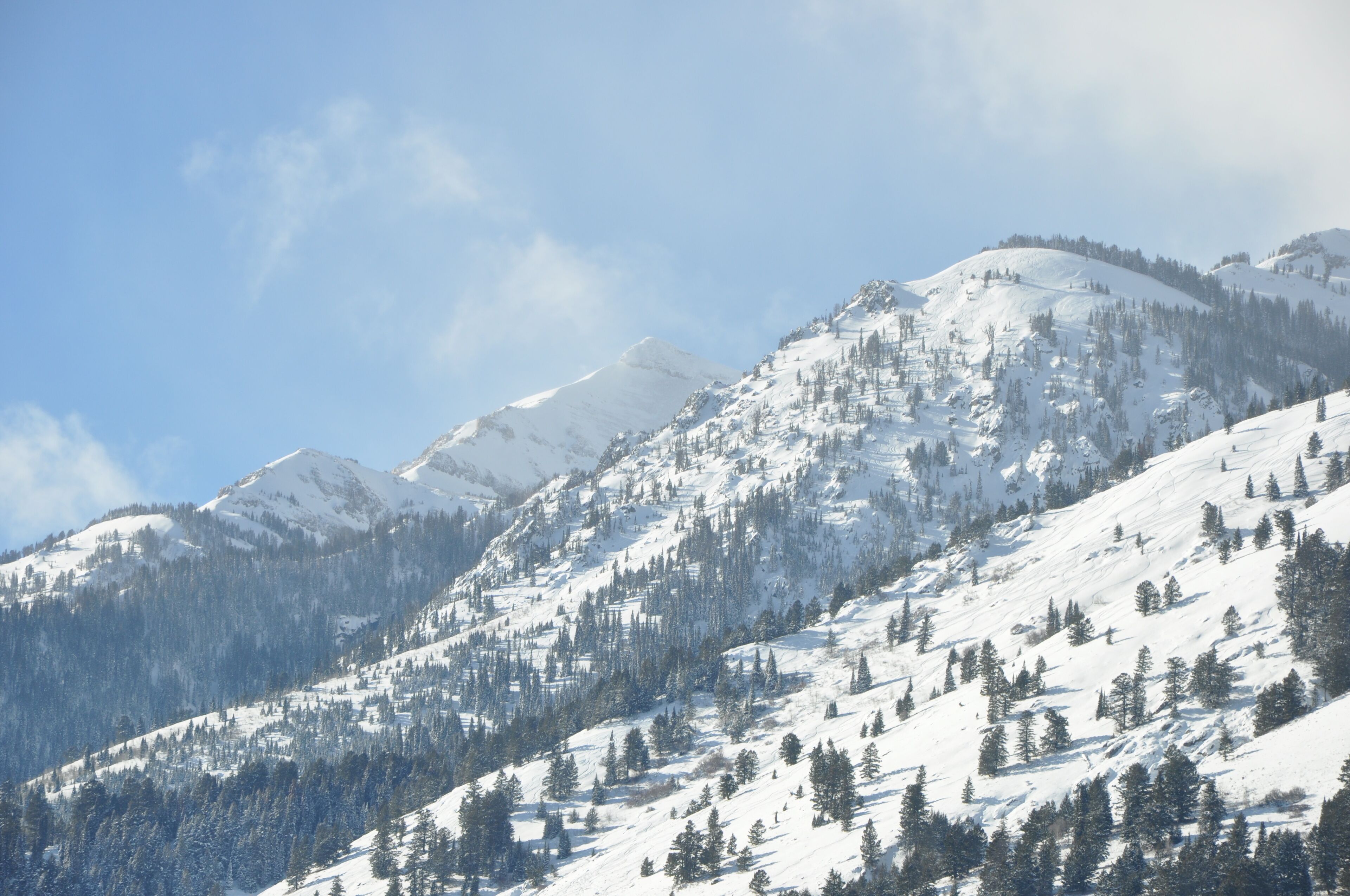 A snow-covered mountain landscape with clear skies.