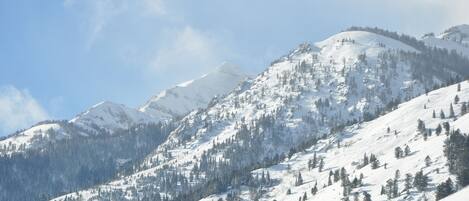 A snow-covered mountain landscape with clear skies.