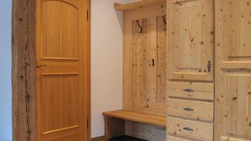 A wooden door, a bench, and a set of drawers.