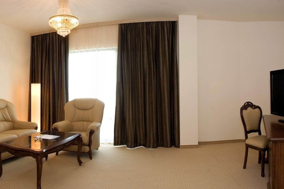 Deluxe Apartment, Balcony | Living room | Flat-screen TV