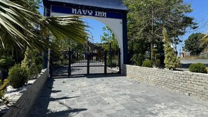 A gated entrance to a building with a sign that reads 'NAVY INN'. - Navyinn Garden (Arnavutköy)