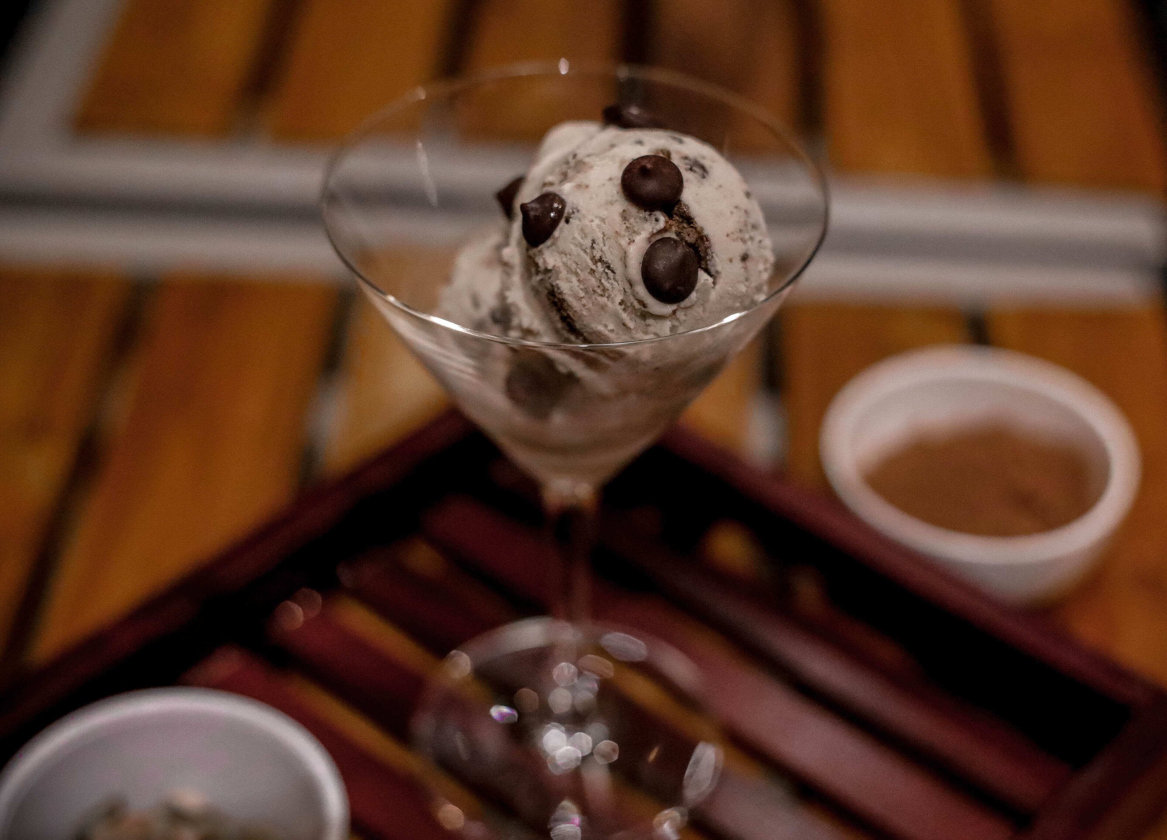 A dessert in a glass on a wooden table.