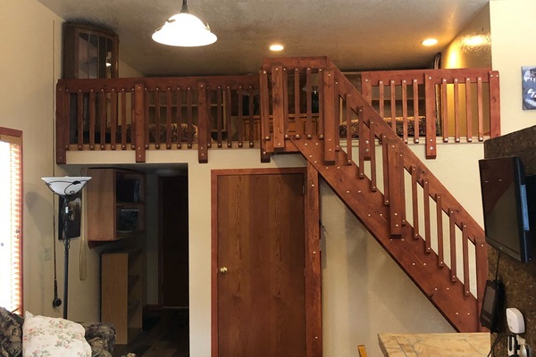 Living room, half loft, master bedroom door and enter and exit hallway