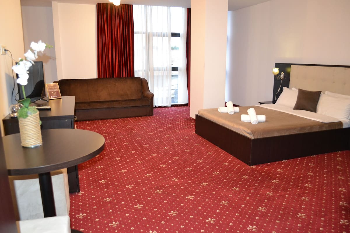 Premium bedding, desk, laptop workspace, iron/ironing board