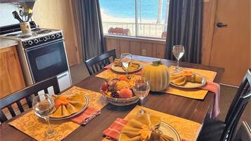 Enjoy meals in this dining area with a view of the sea through large windows.