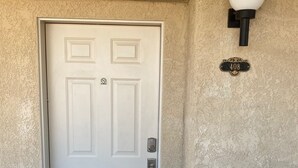 A white door with a keypad lock, a mailbox, and a '408' address plaque on the wall. - Kings View Condo, Boaters paradise, Unit 408 (Lake Havasu City)