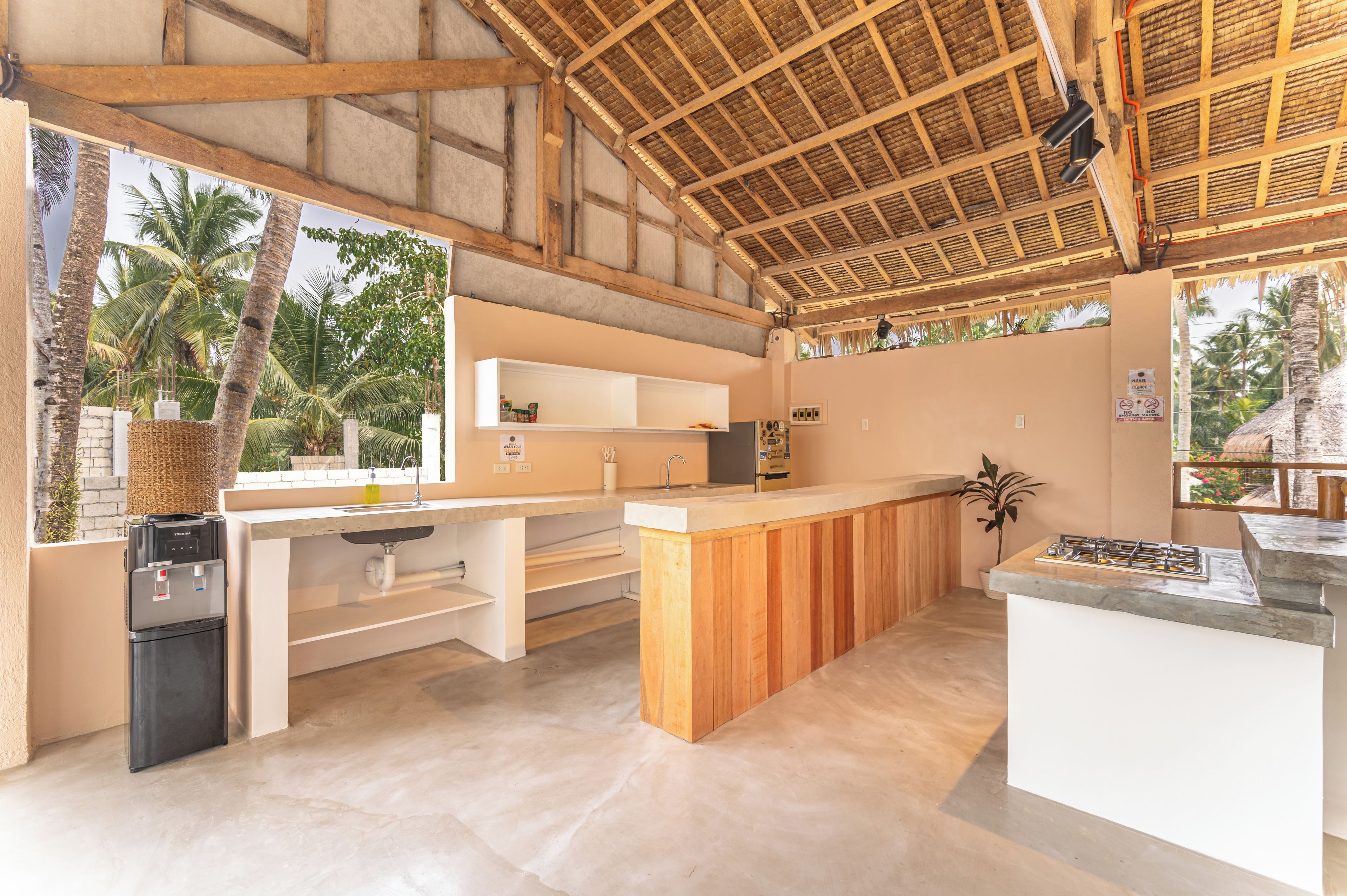 A modern kitchen with a built-in refrigerator, a sink, and a stove.