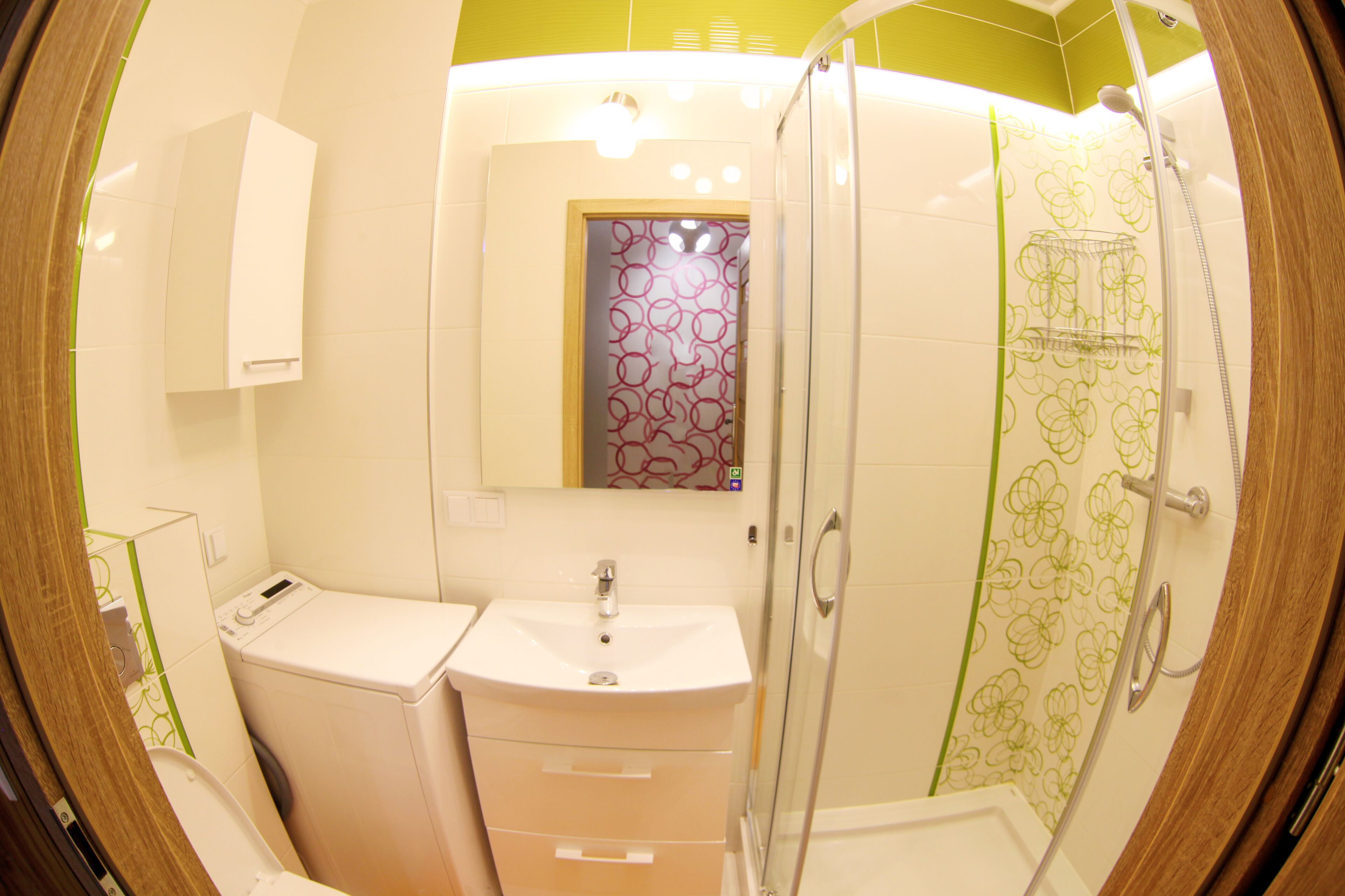 A bathroom with a toilet, sink, and shower.