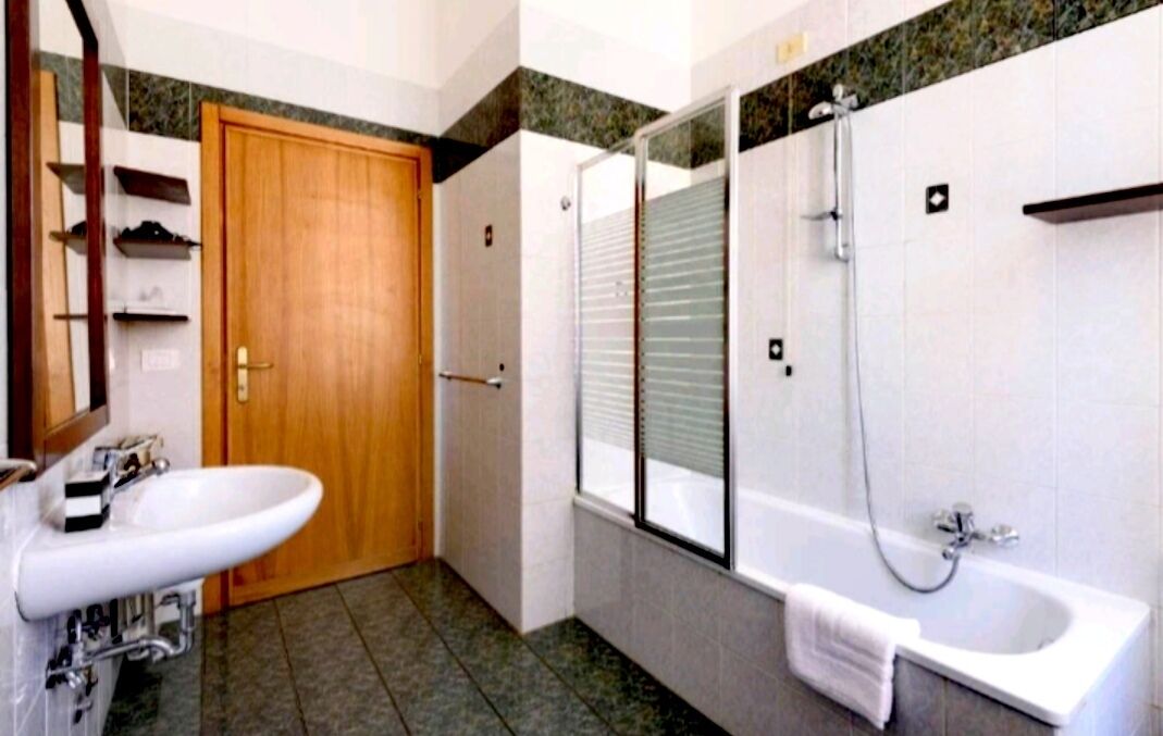 A bathroom with a sink, toilet, and bathtub.