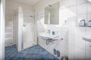Shower, hair dryer, towels, toilet paper