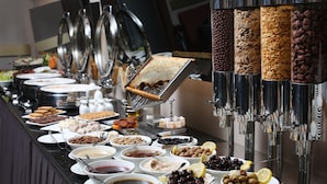 A buffet with various food items and condiments. - Mardin Airport Otel (Kiziltepe)
