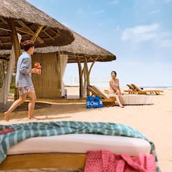 On the beach, white sand, beach umbrellas, beach towels