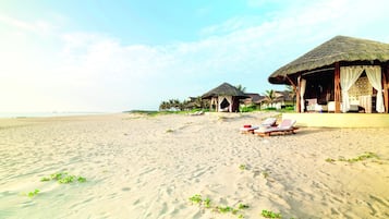 On the beach, white sand, beach umbrellas, beach towels