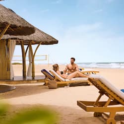 On the beach, white sand, beach umbrellas, beach towels