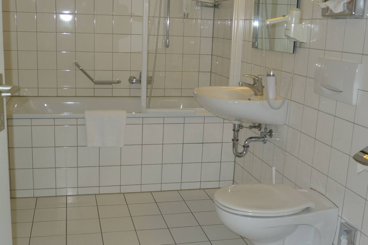 A bathroom with a bathtub, sink, and toilet.