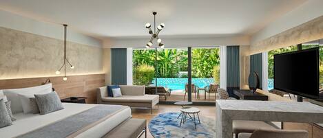 A modern hotel room with a large bed, a sofa, a TV, and a view of a swimming pool.