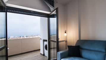 Apartment, 1 Bedroom (Blu) | Living area | Flat-screen TV