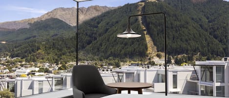 A modern room with a large window overlooking a mountainous landscape.