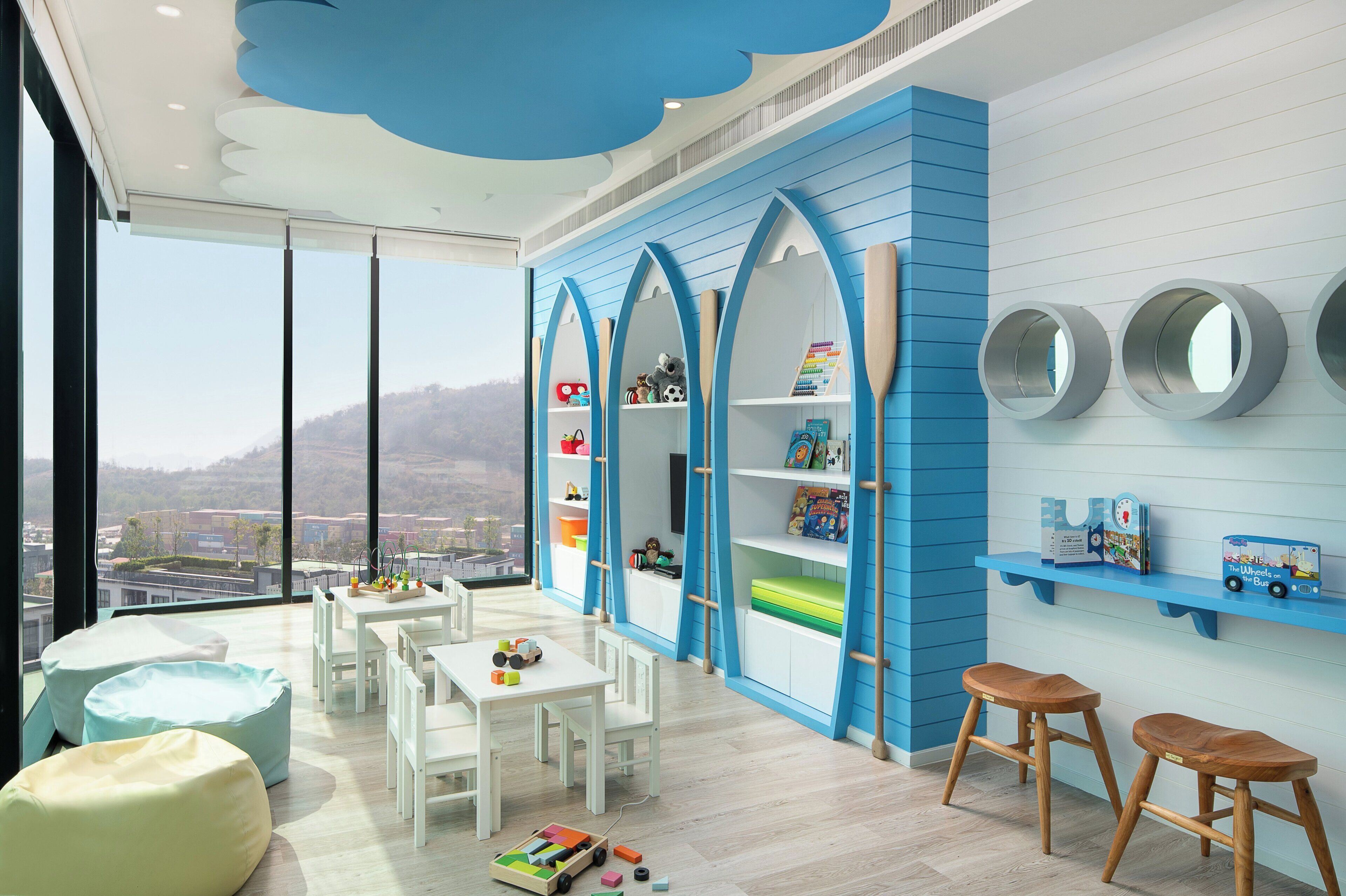 A children's playroom with a view of the city.