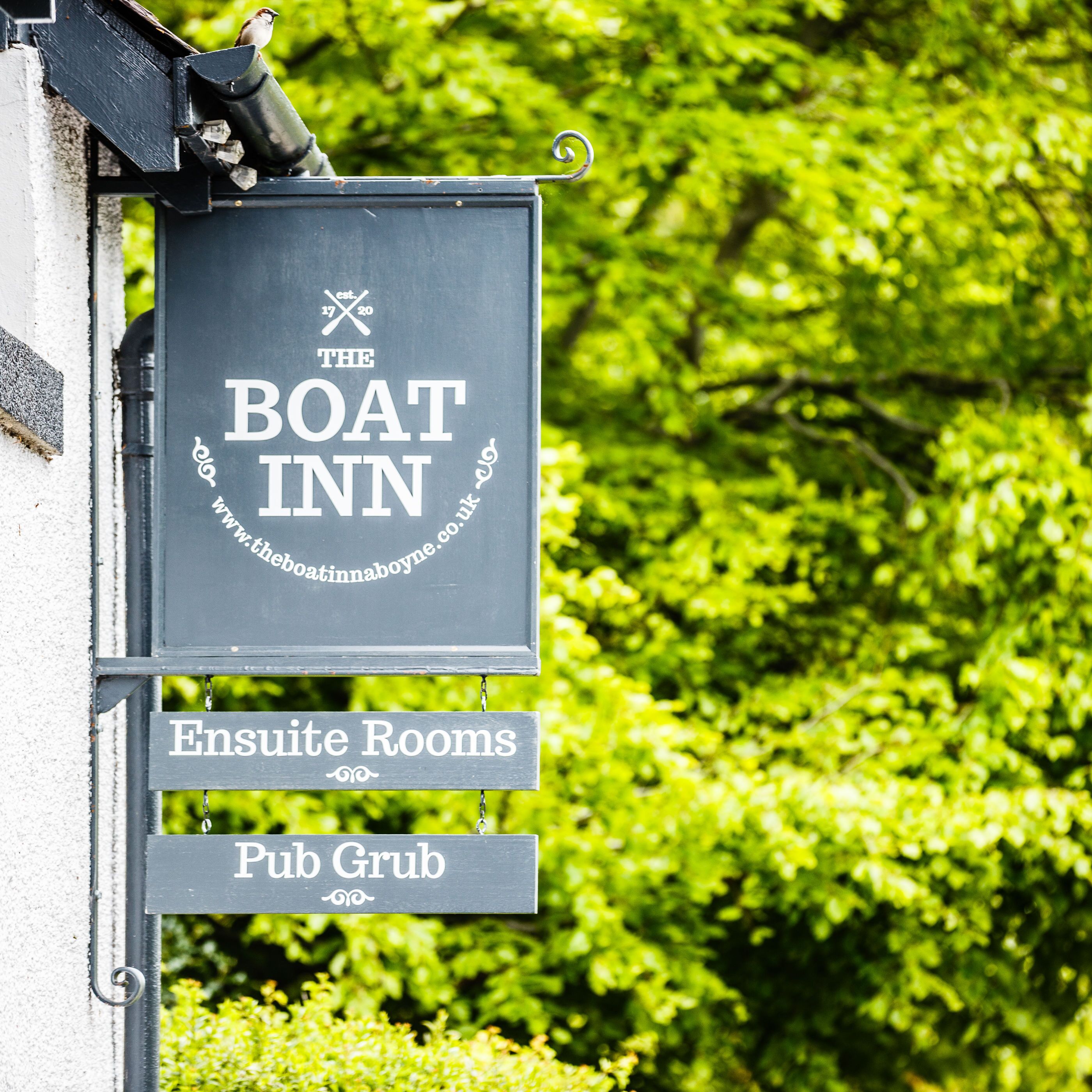 A signboard for 'The Boat Inn' with 'Ensuite Rooms' and 'Pub Grub' listed below.