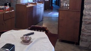 A rustic kitchen with stone walls, wooden cabinets, and a central island. - Safranbolu Konagi (Safranbolu)